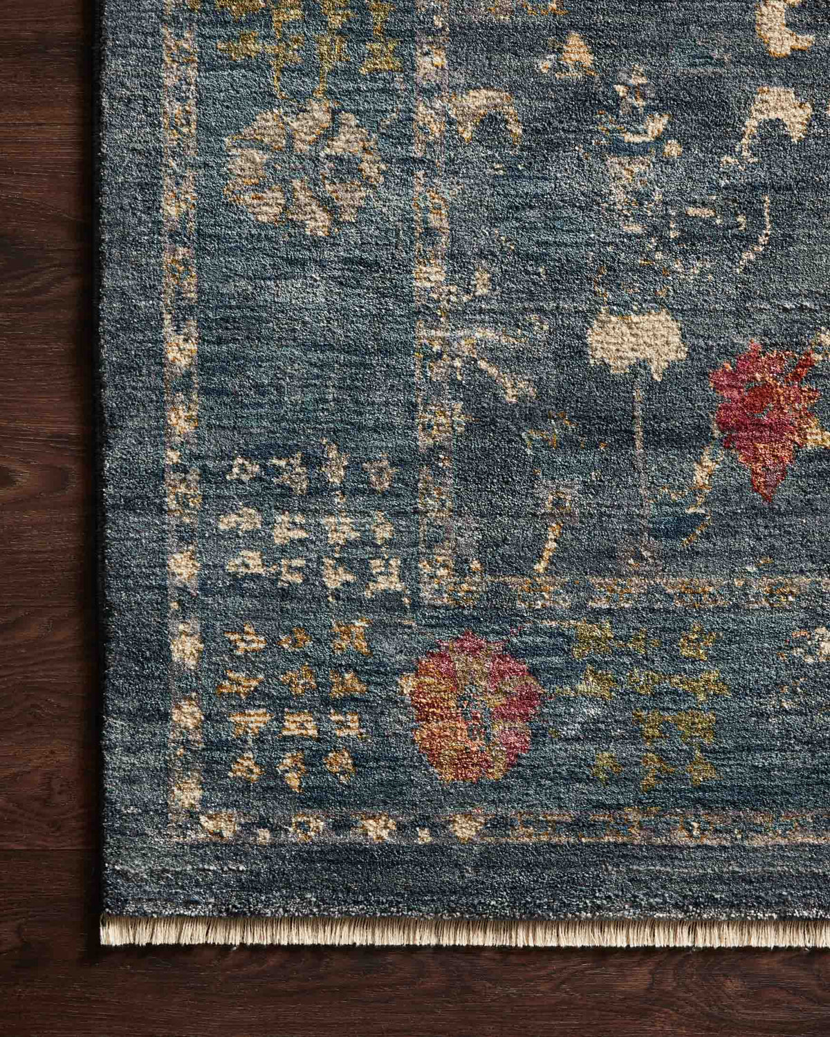 Blue vintage-style rug with floral motifs and ornate border design