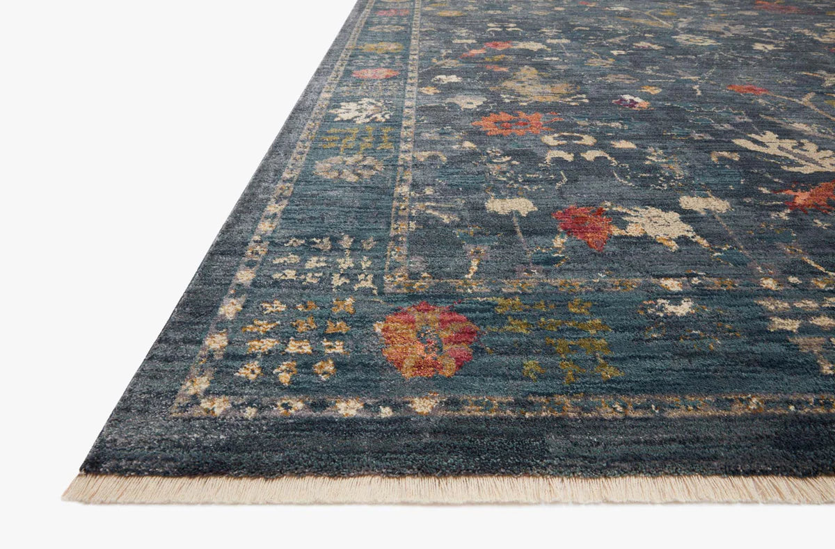 Blue vintage-style rug with floral motifs and ornate border design