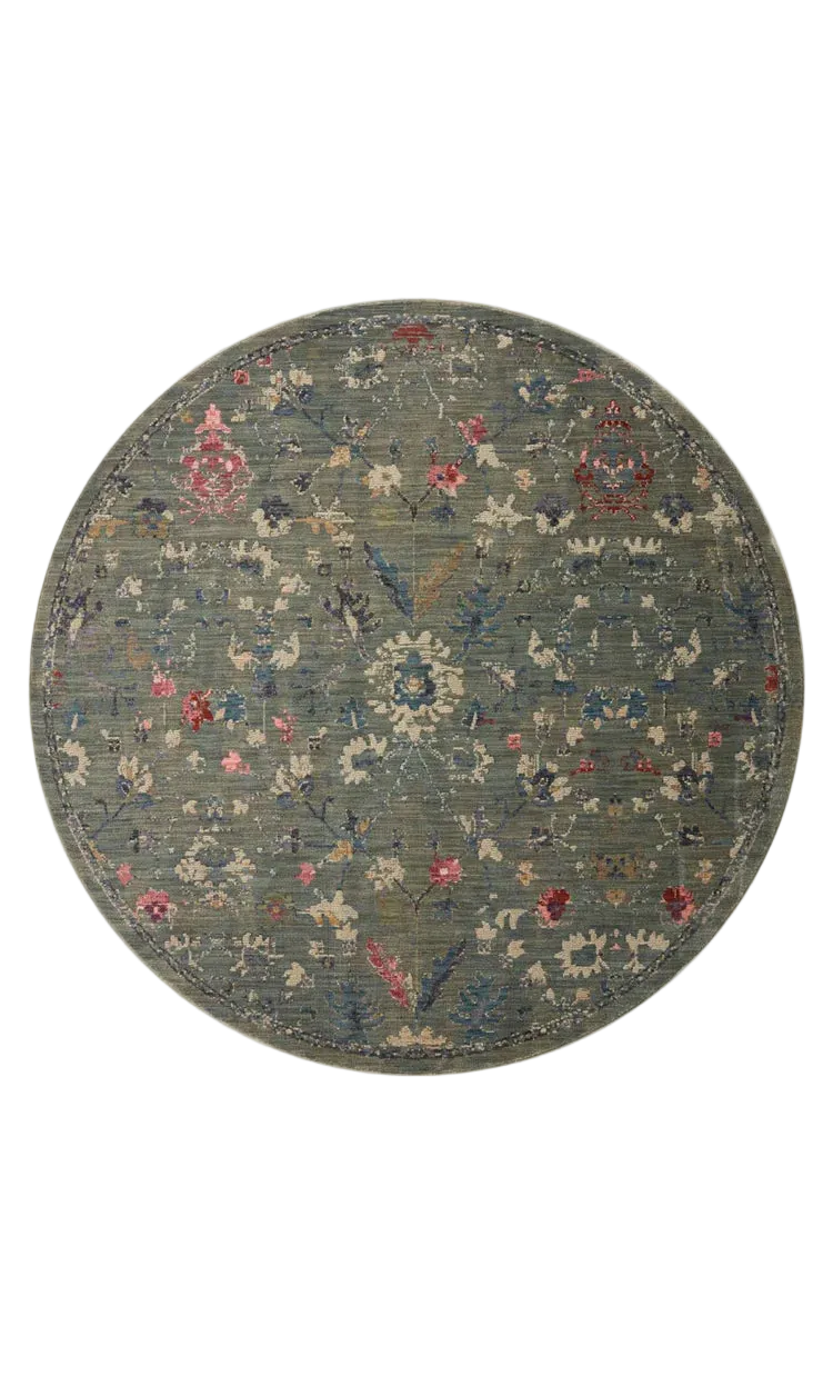 Vintage-style rug with blue-gray base and faded floral pattern in cream and red tones