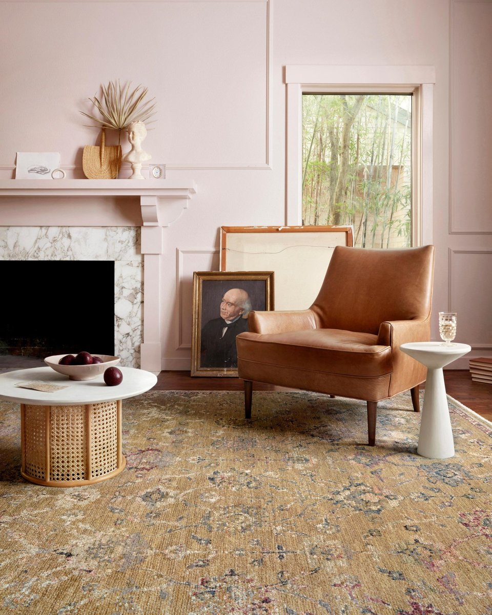 Vintage-inspired area rug with warm tan, blue, and purple tones in traditional pattern