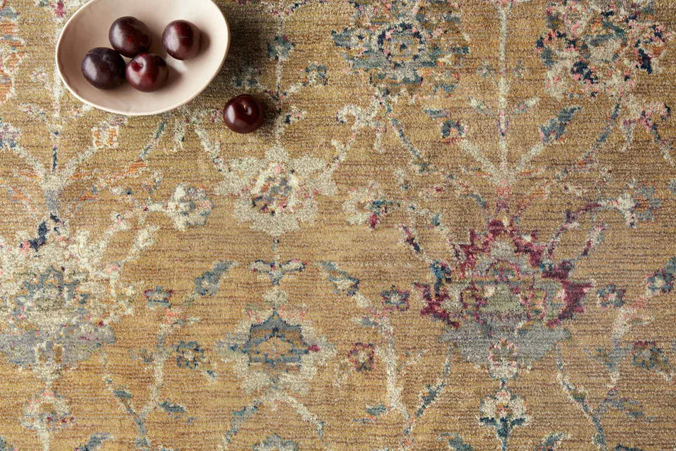 Vintage-inspired area rug with warm tan, blue, and purple tones in traditional pattern