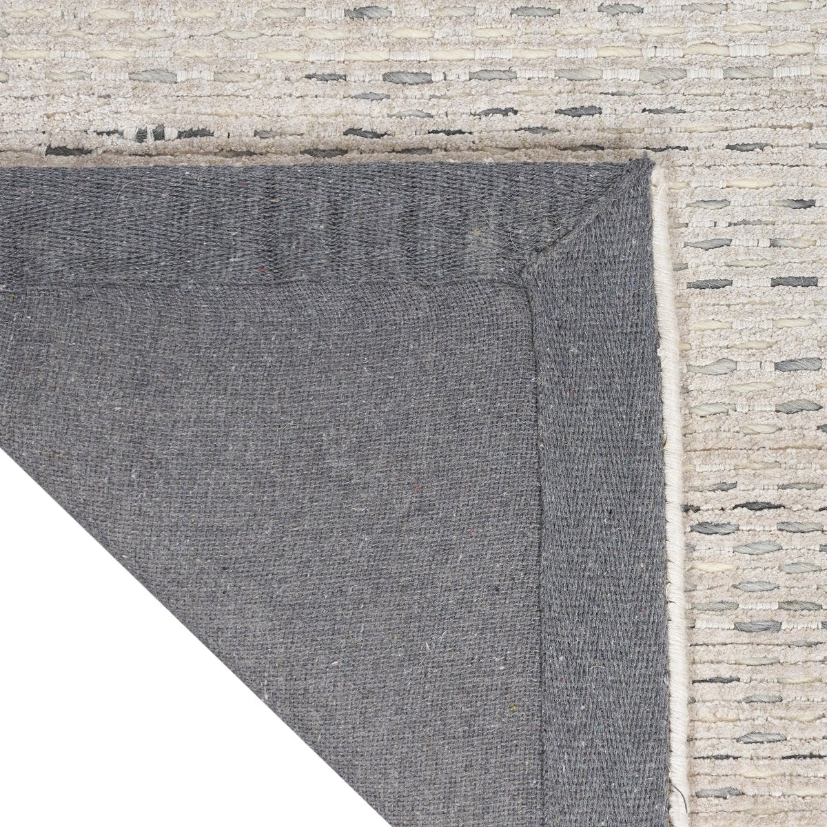 Neutral beige textured area rug with subtle linear pattern and natural fiber appearance