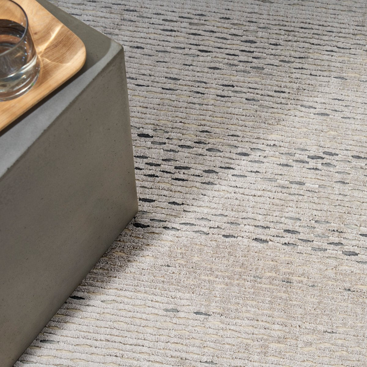 Neutral beige textured area rug with subtle linear pattern and natural fiber appearance