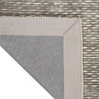 Grey textured rug with subtle horizontal striations and mottled appearance throughout