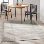 Grey textured rug with subtle horizontal striations and mottled appearance throughout