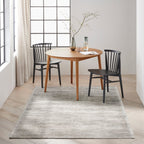 Grey textured rug with subtle horizontal striations and mottled appearance throughout