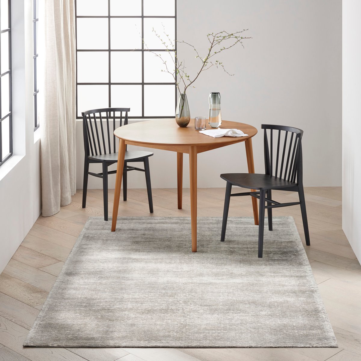 Grey textured rug with subtle horizontal striations and mottled appearance throughout