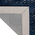 Dark blue textured area rug with subtle horizontal striations and woven pattern