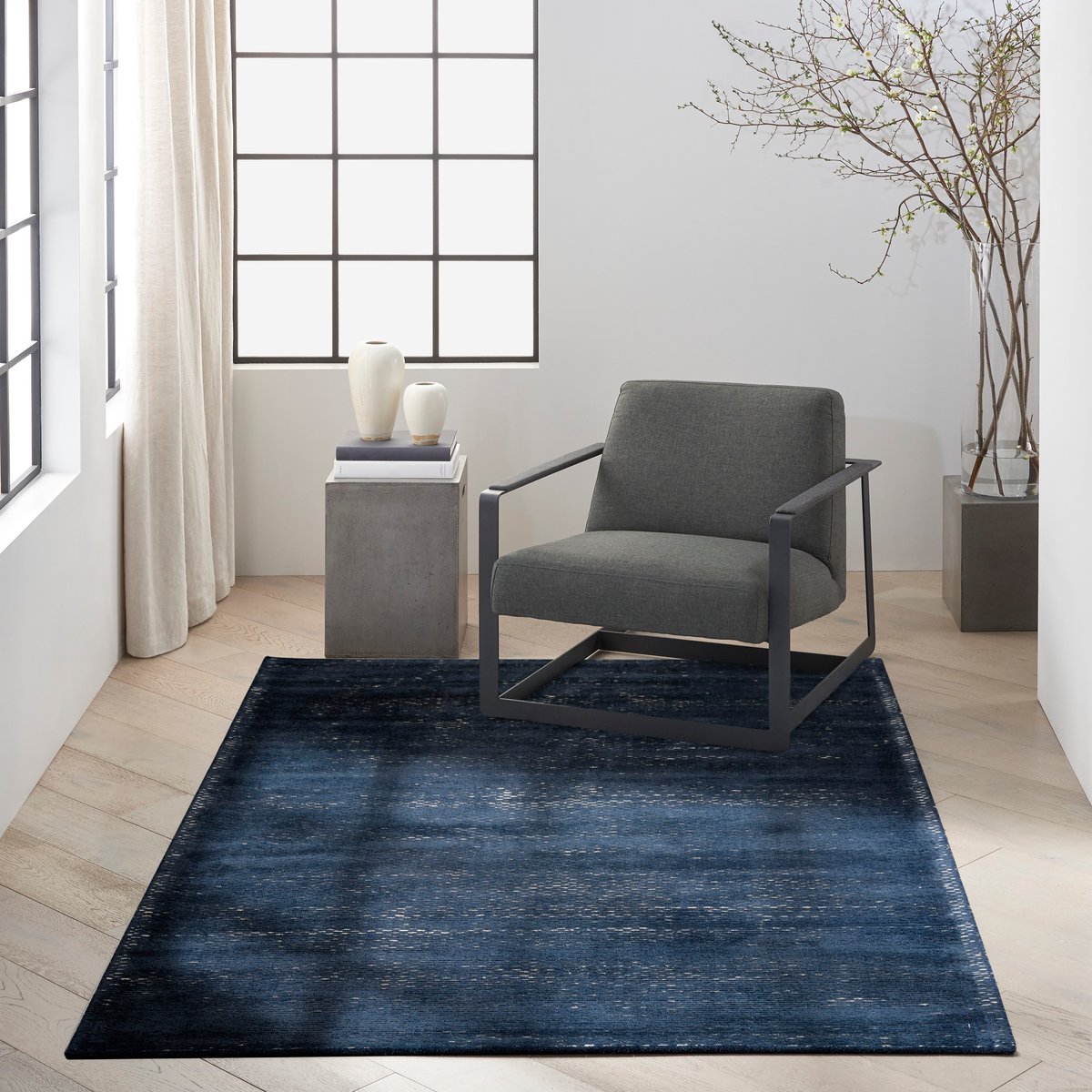 Dark blue textured area rug with subtle horizontal striations and woven pattern