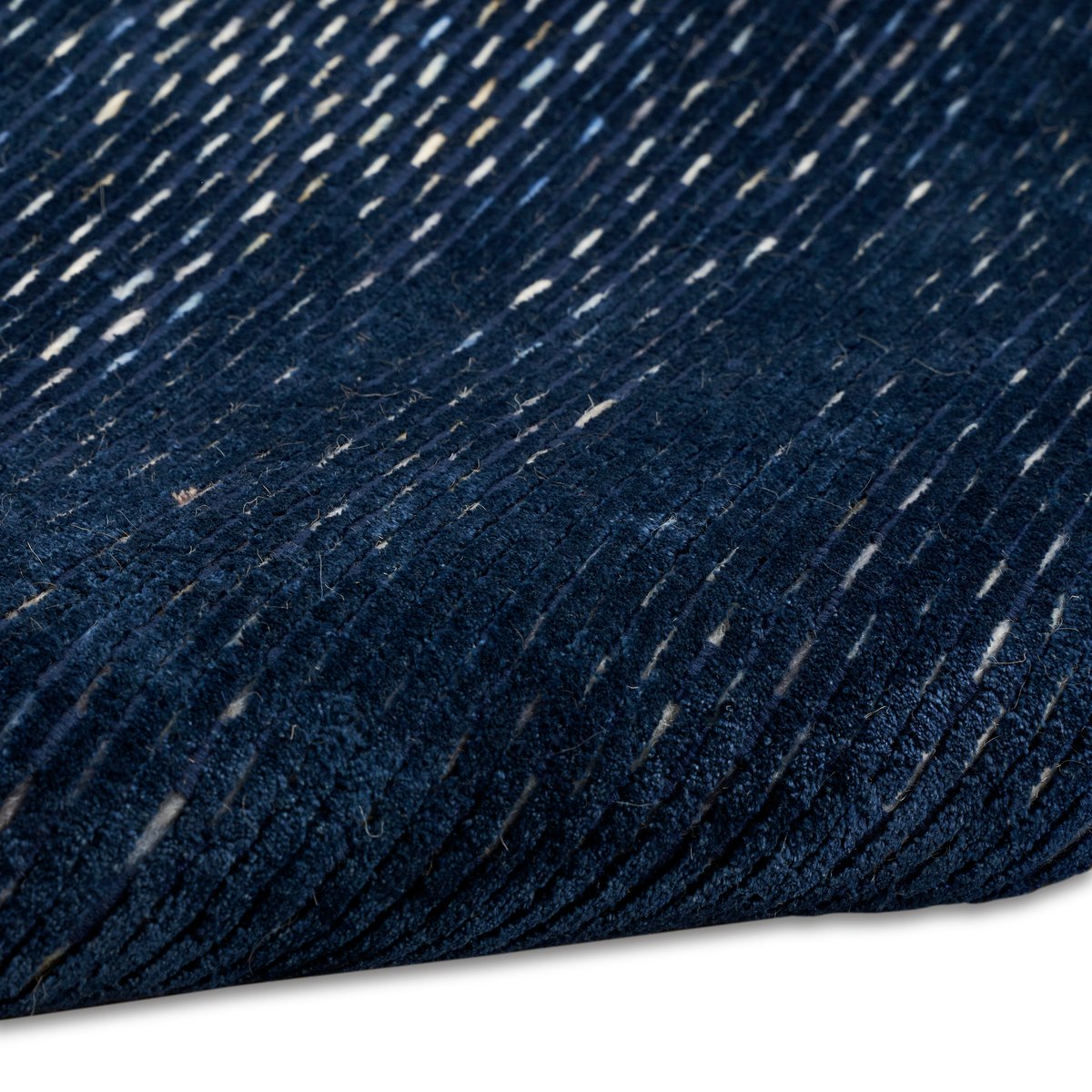 Dark blue textured area rug with subtle horizontal striations and woven pattern