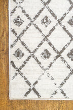 Cream and grey diamond pattern rug with tassel fringe detailing