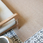 Natural beige textured woven rug with subtle crosshatch pattern