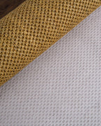 Natural woven jute rug with tight diagonal weave texture in tan and beige tones