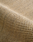 Beige woven sisal rug with diagonal ribbed texture pattern