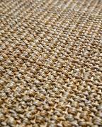 Natural woven jute rug with tight basket weave texture in tan and beige