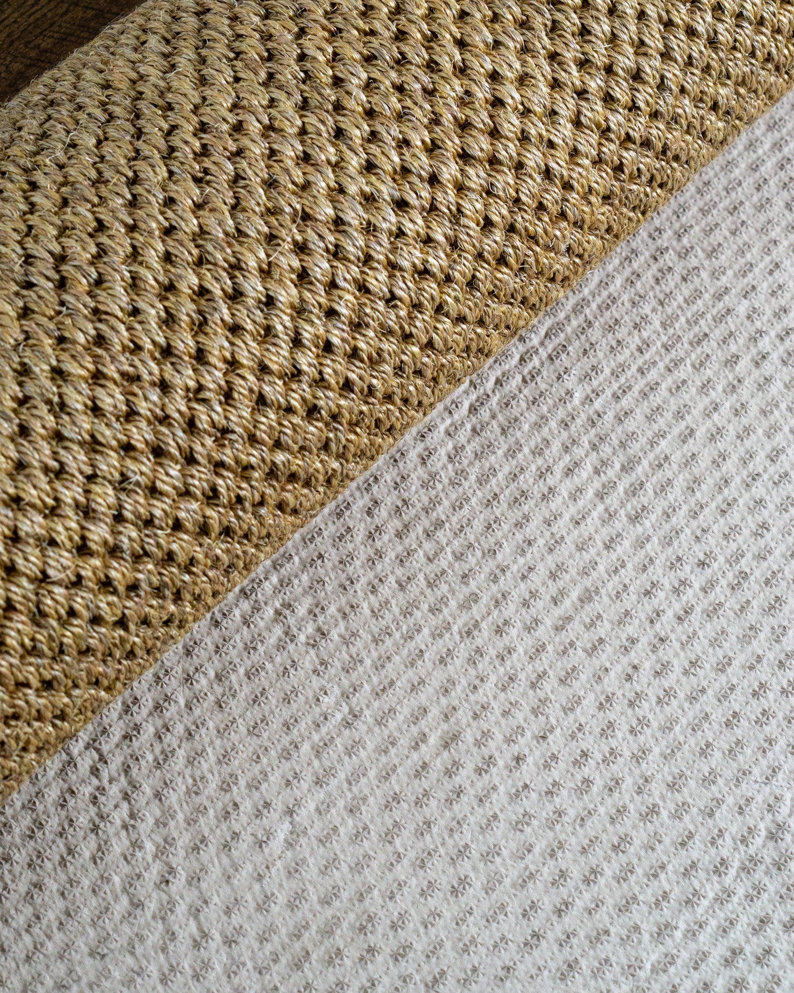 Beige woven sisal rug with diagonal ribbed texture pattern