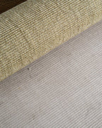 Natural woven texture rug with neutral tan and beige tones in flat weave style
