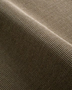 Olive green textured wool rug with tight woven pattern in neutral tone