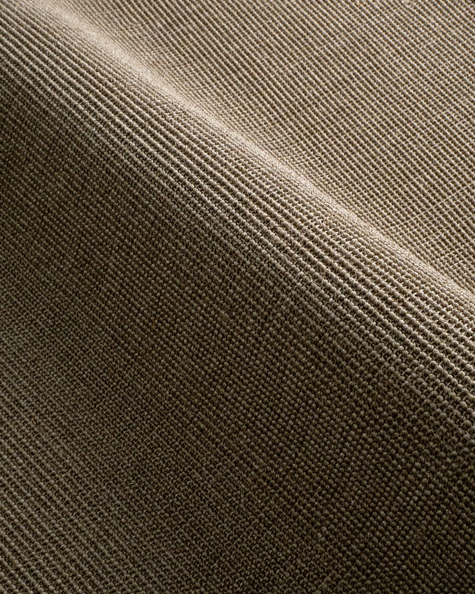 Olive green textured wool rug with tight woven pattern in neutral tone
