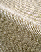 Neutral beige textured woven rug with ribbed pattern in natural fibers