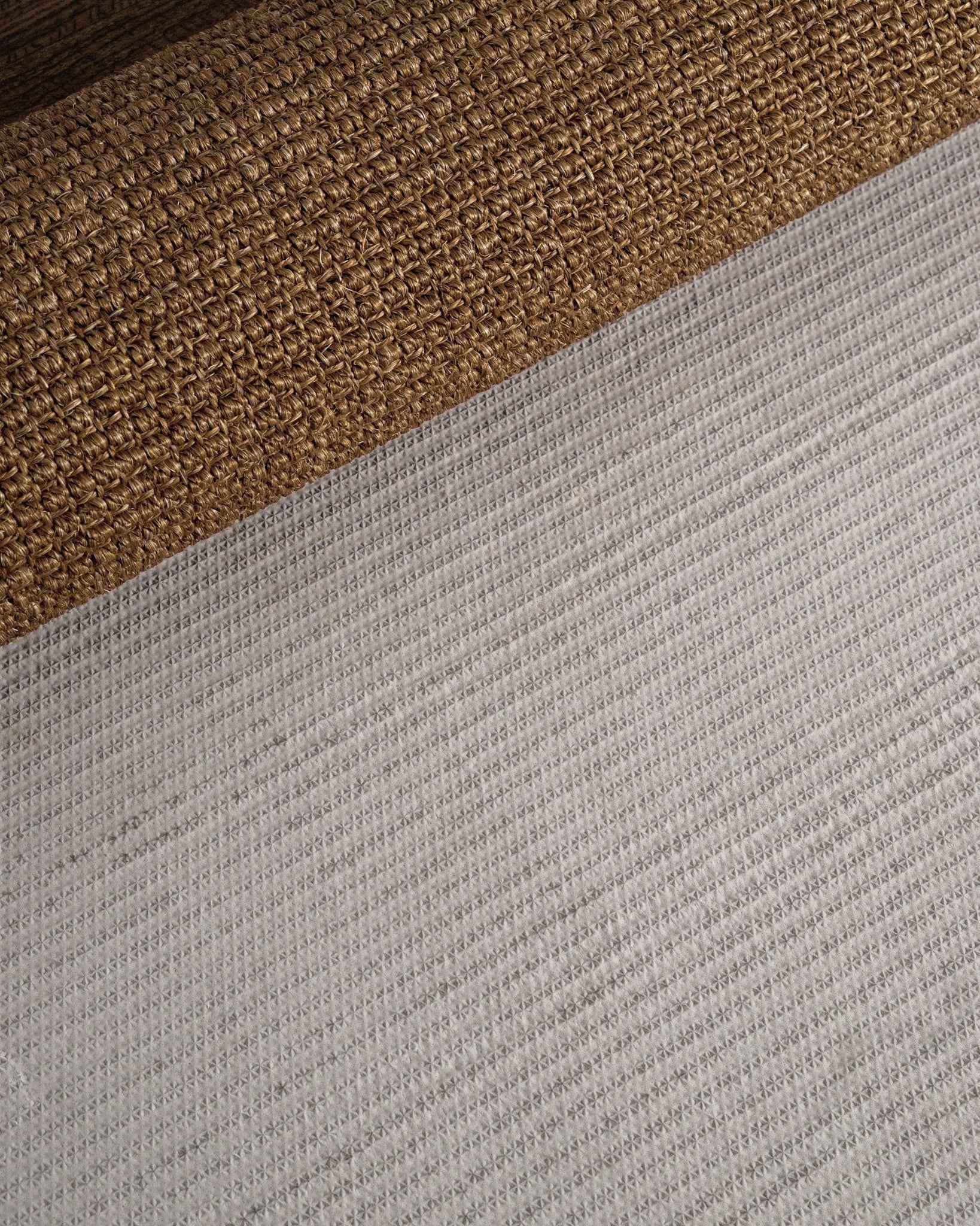 Woven natural fiber rug with tan and brown textured striped pattern
