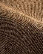 Woven natural fiber rug with tan and brown textured striped pattern