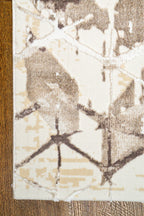 Beige isometric geometric rug with brown abstract pattern and distressed texture