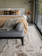 Beige isometric geometric rug with brown abstract pattern and distressed texture