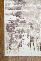 Distressed cream and grey area rug with vintage abstract pattern and worn texture