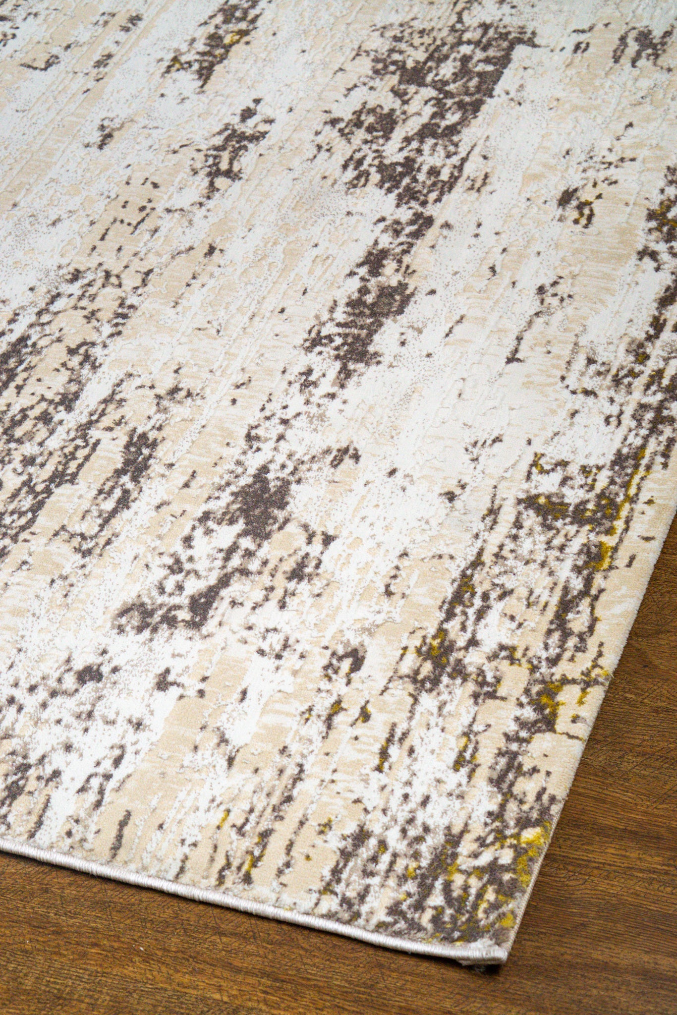 Distressed beige and grey rug with abstract texture and worn vintage aesthetic