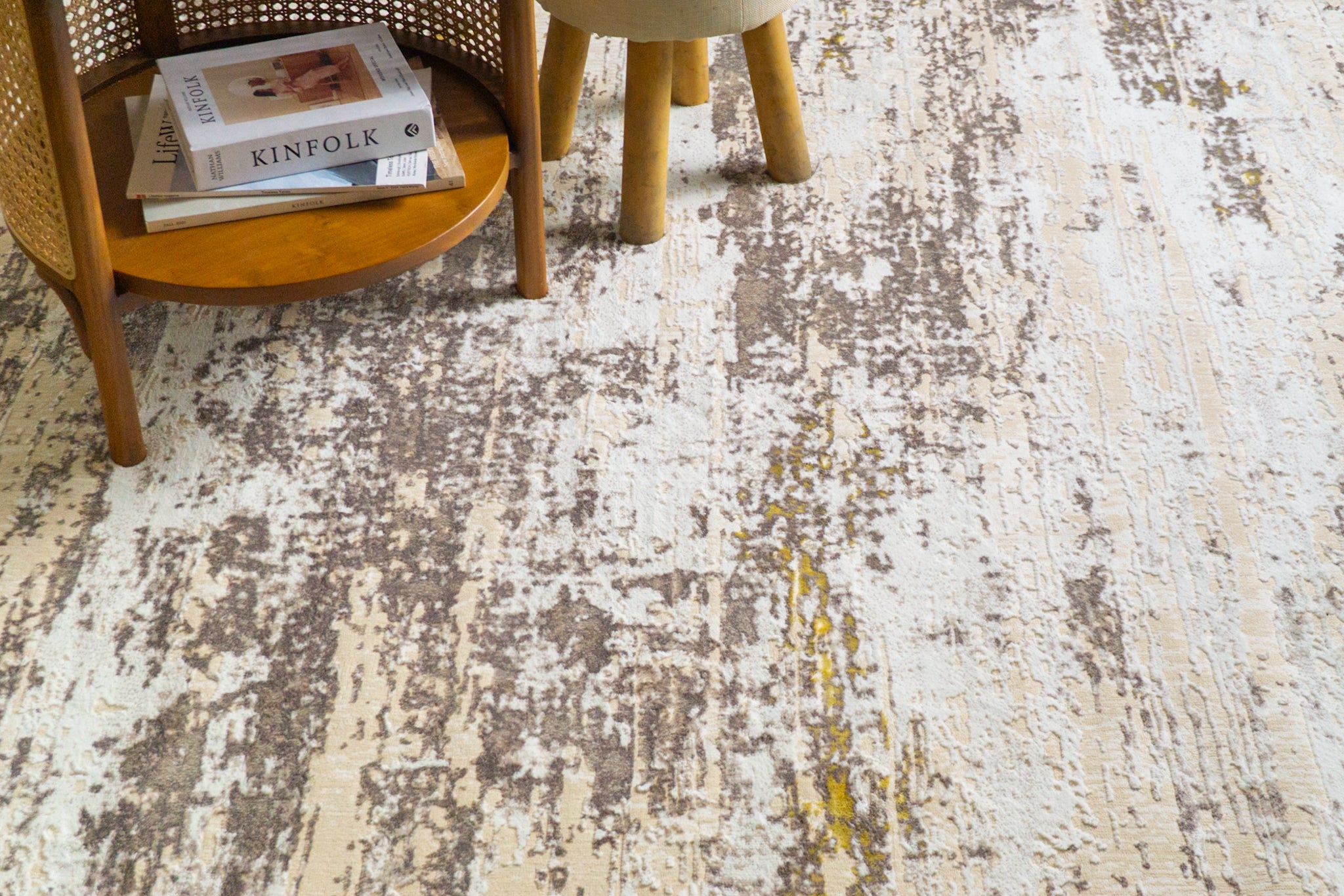 Distressed beige and grey rug with abstract texture and worn vintage aesthetic