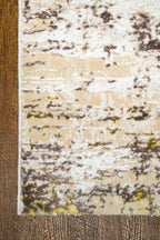 Distressed beige and grey rug with abstract texture and worn vintage aesthetic