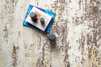 Distressed beige and grey rug with abstract texture and worn vintage aesthetic
