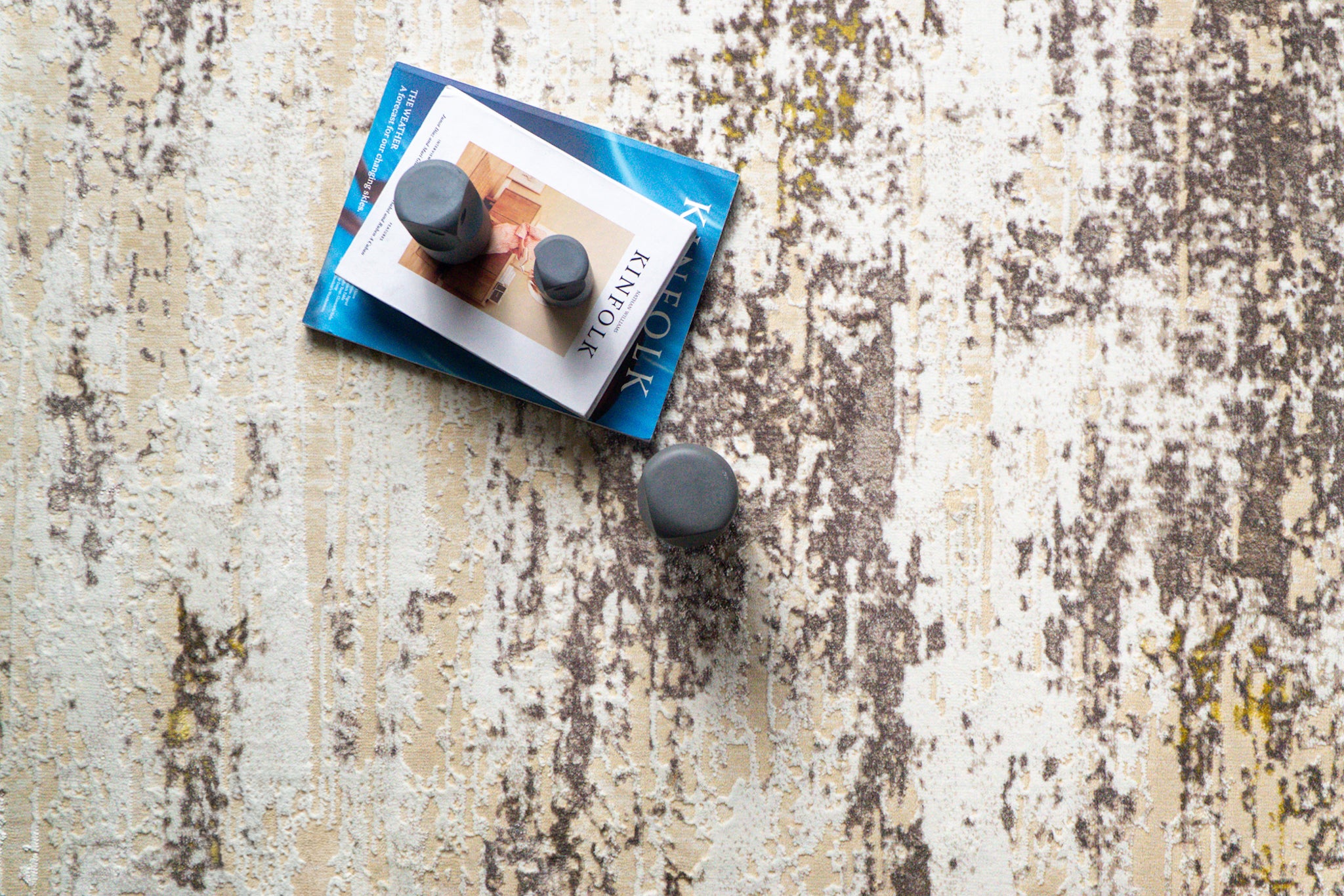 Distressed beige and grey rug with abstract texture and worn vintage aesthetic