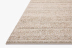 Beige textured area rug with horizontal woven pattern in neutral tones