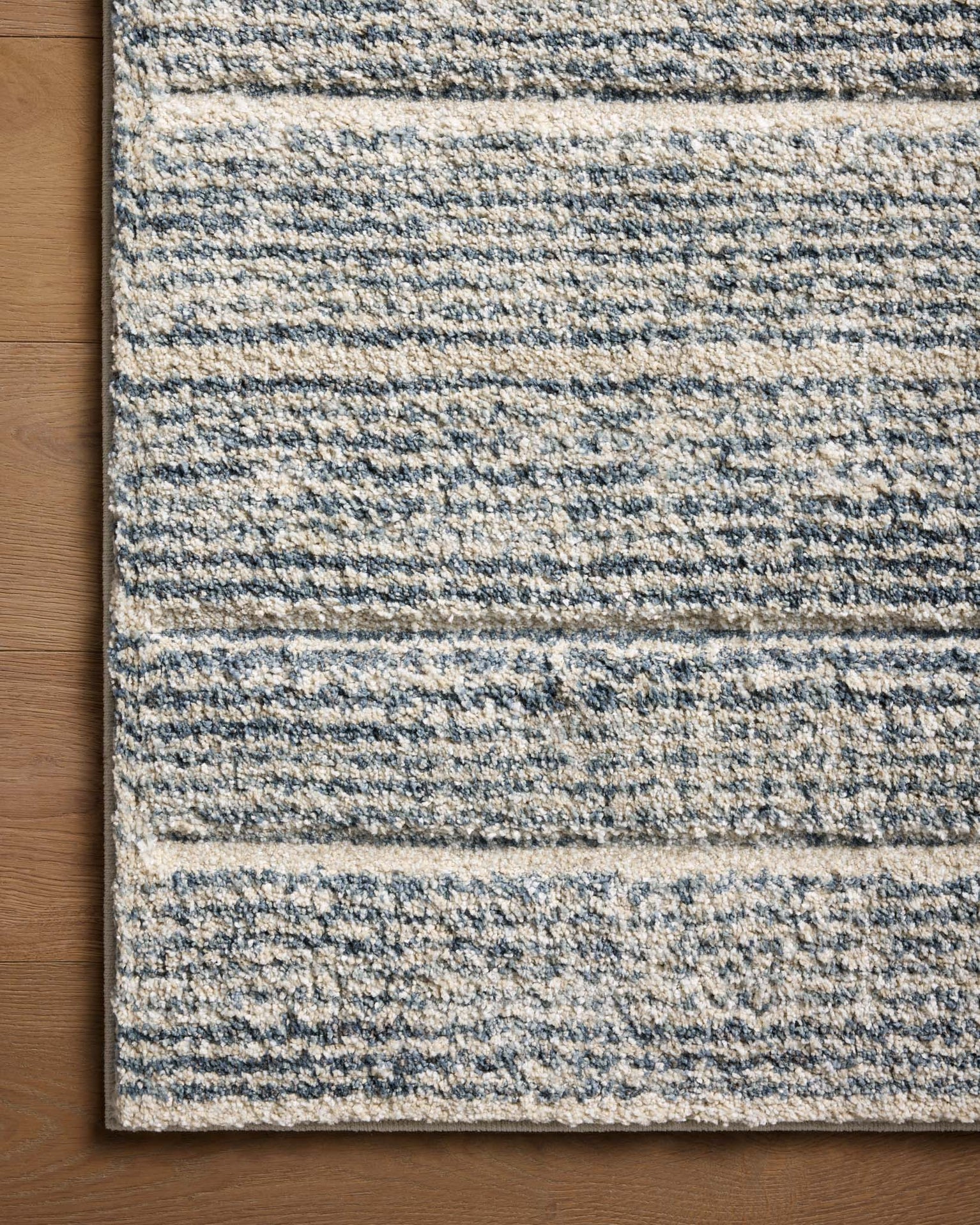 Modern striped area rug in grey, beige and cream tones with textured weave