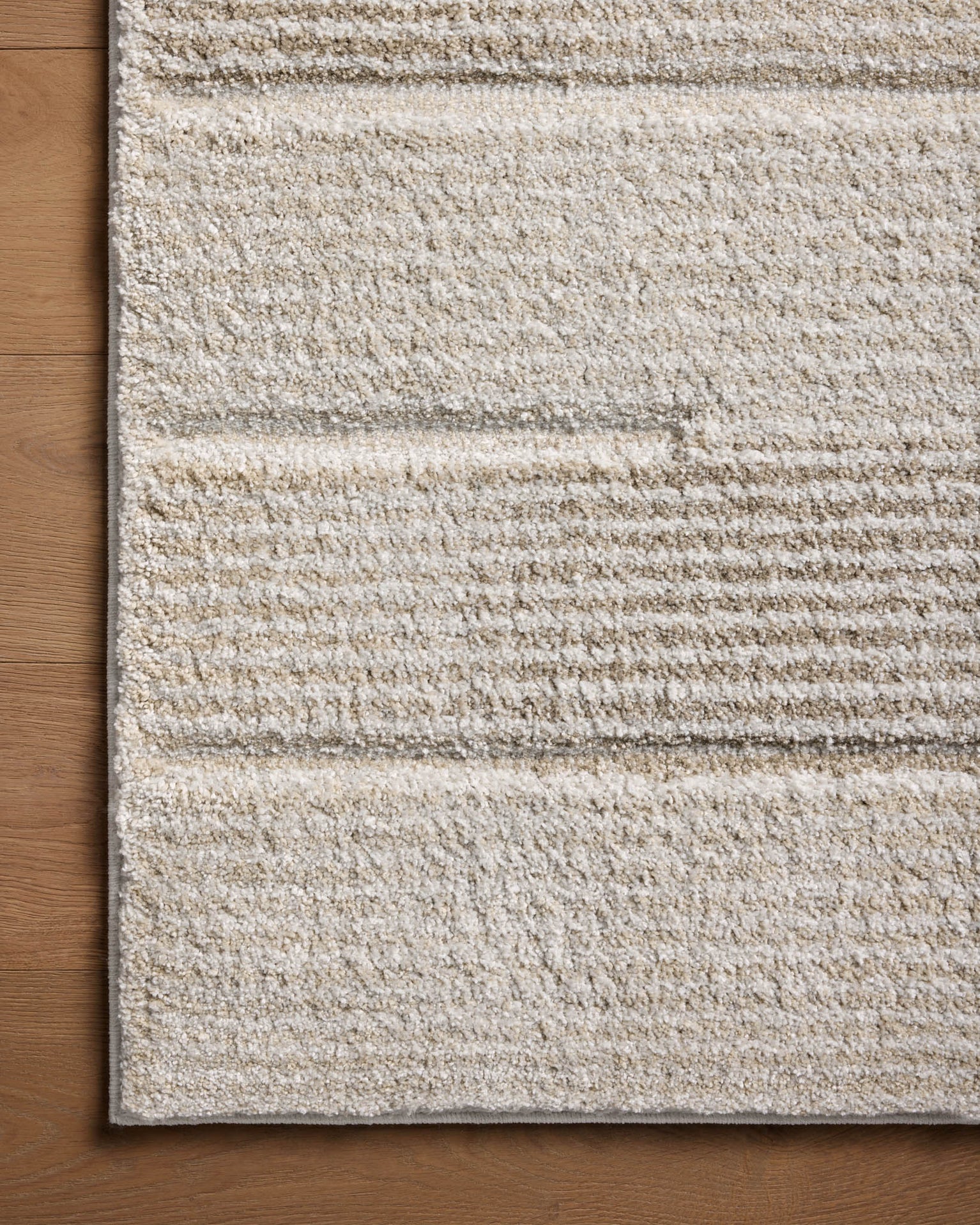 Neutral beige striped area rug with subtle texture and horizontal pattern detail