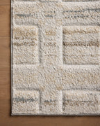 Beige geometric patterned rug with grey accents and textured wool construction
