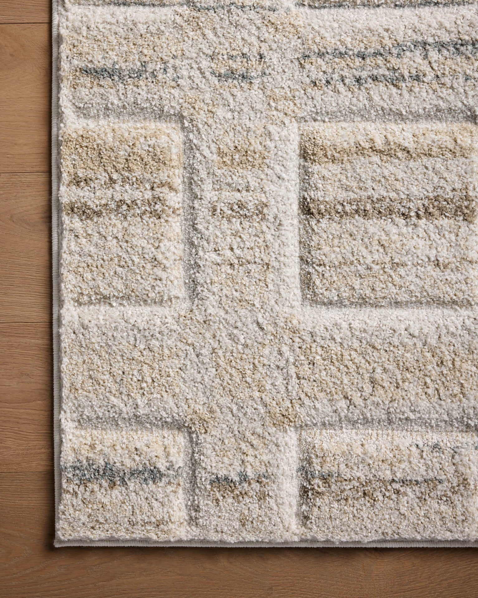 Beige geometric patterned rug with grey accents and textured wool construction