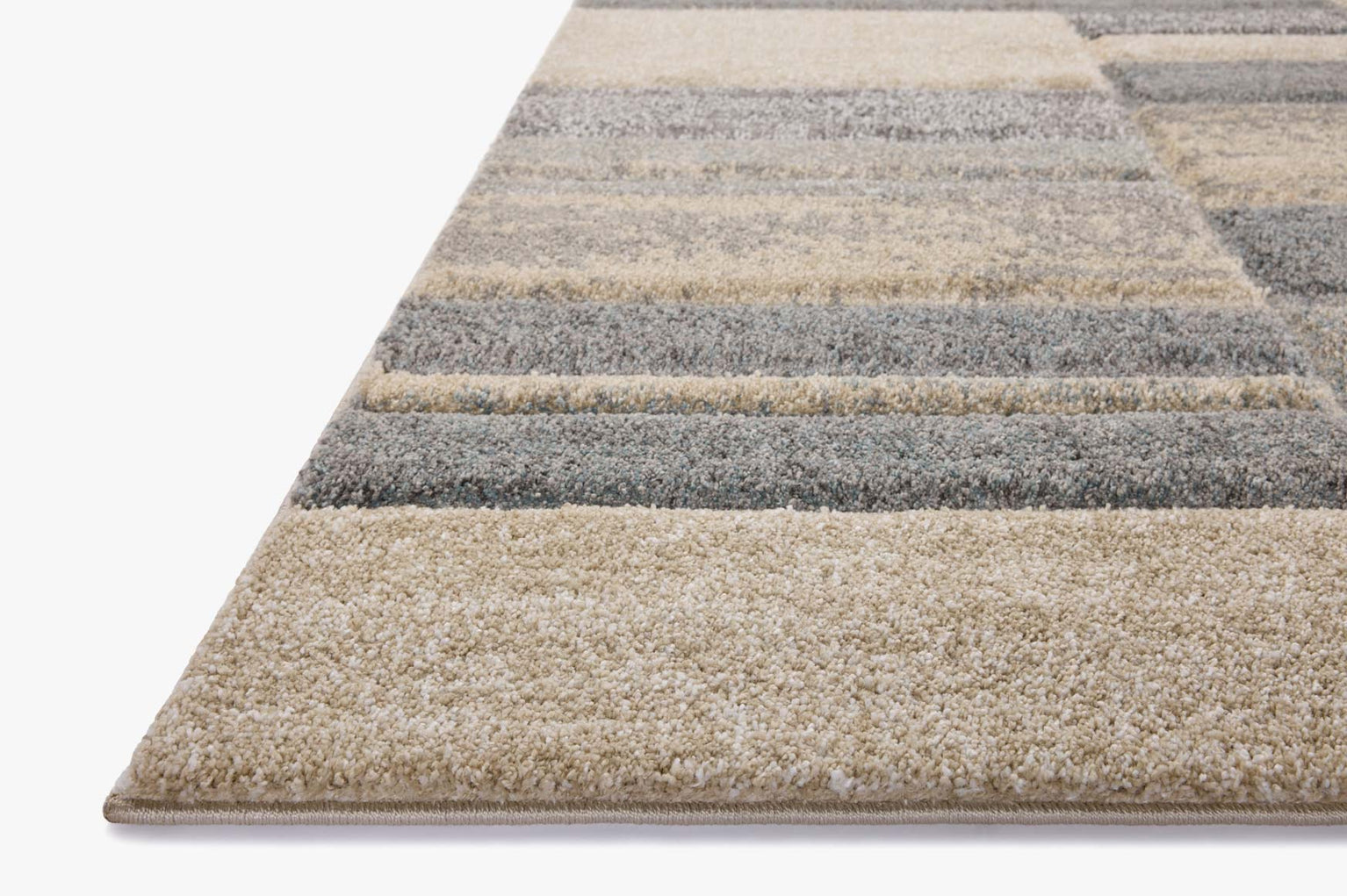 Modern geometric block pattern area rug in grey, beige and tan tones