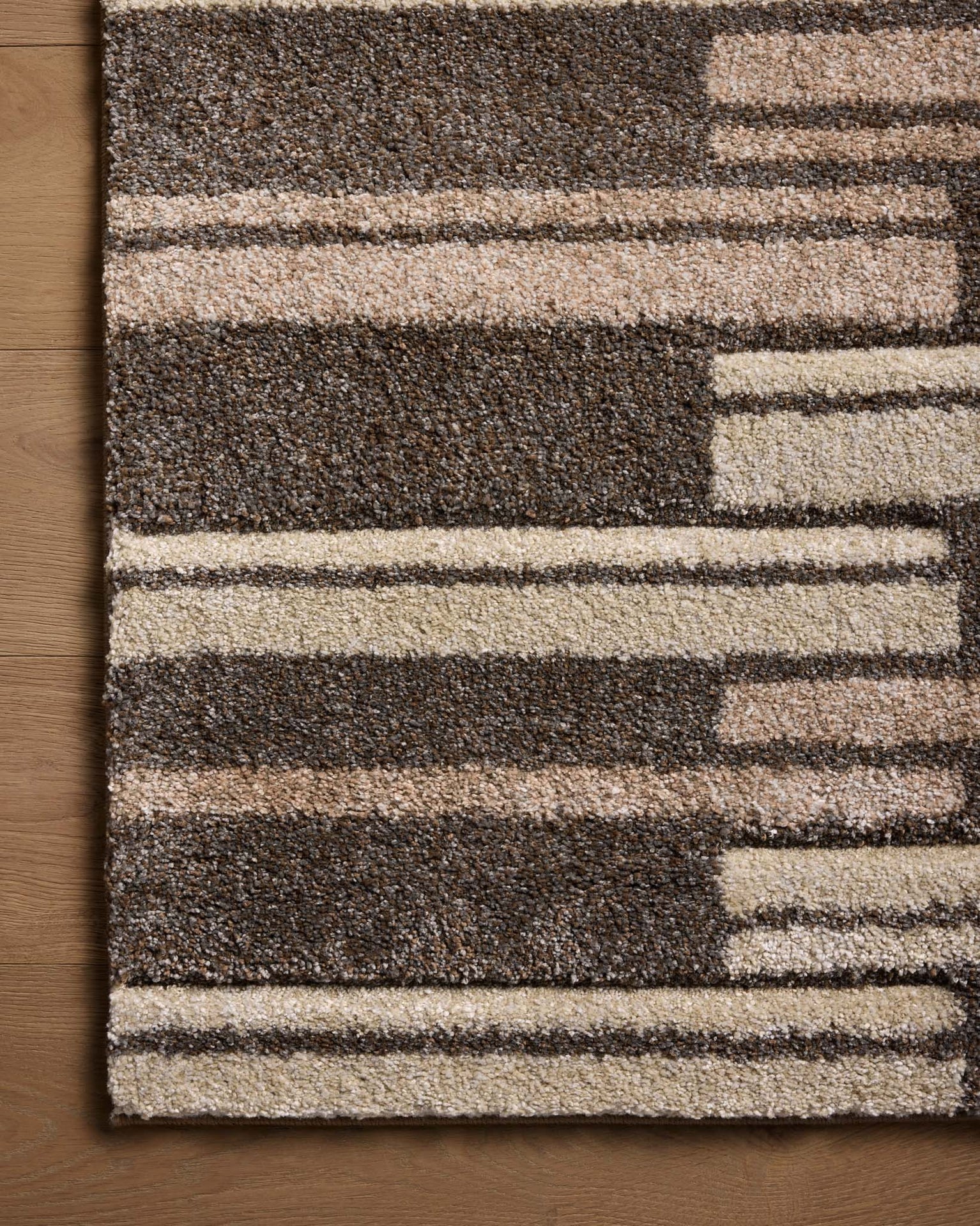 Modern geometric striped rug in brown and beige tones with textured pattern