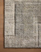 Beige and gray geometric patterned rug with textured woven surface