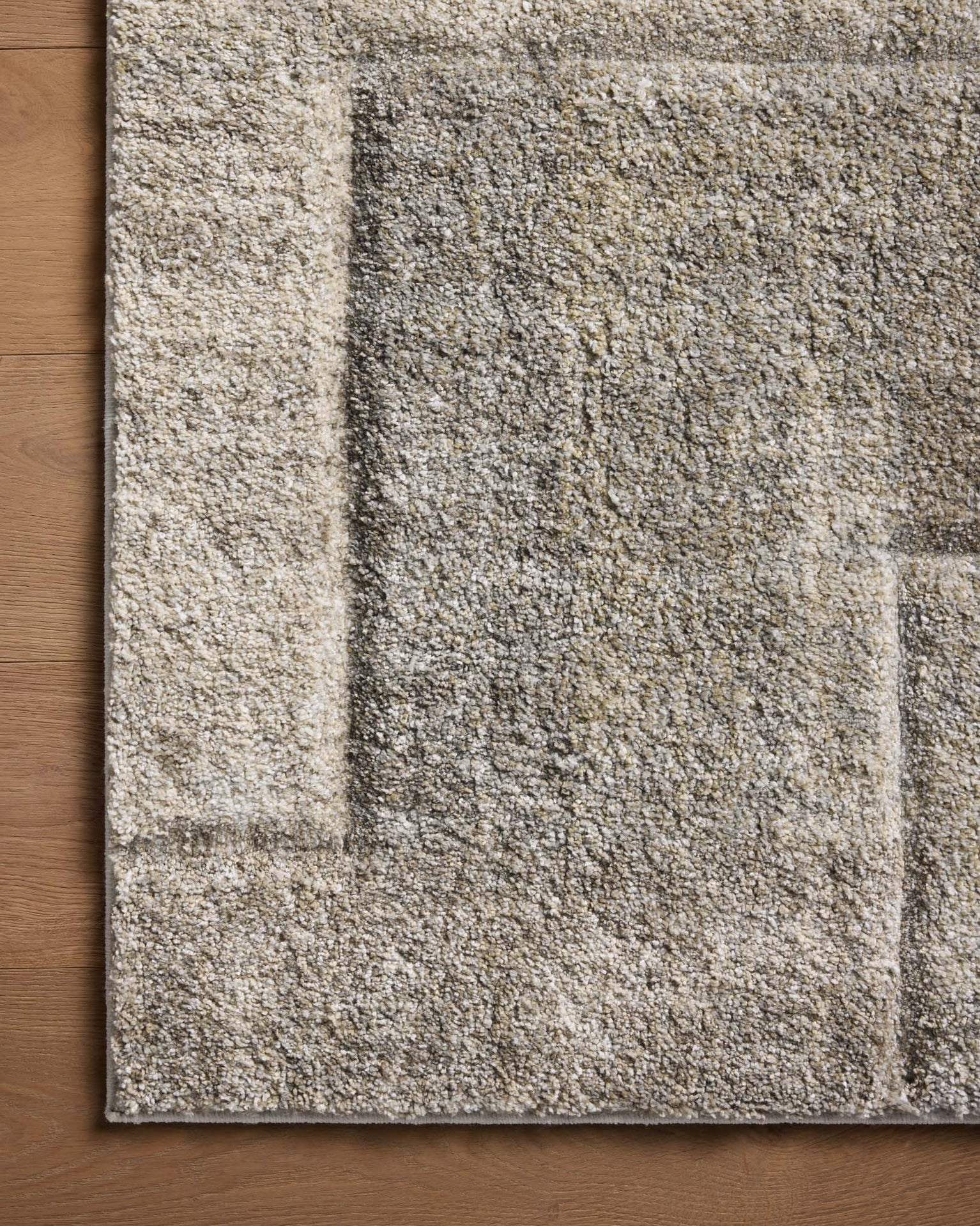 Beige and gray geometric patterned rug with textured woven surface