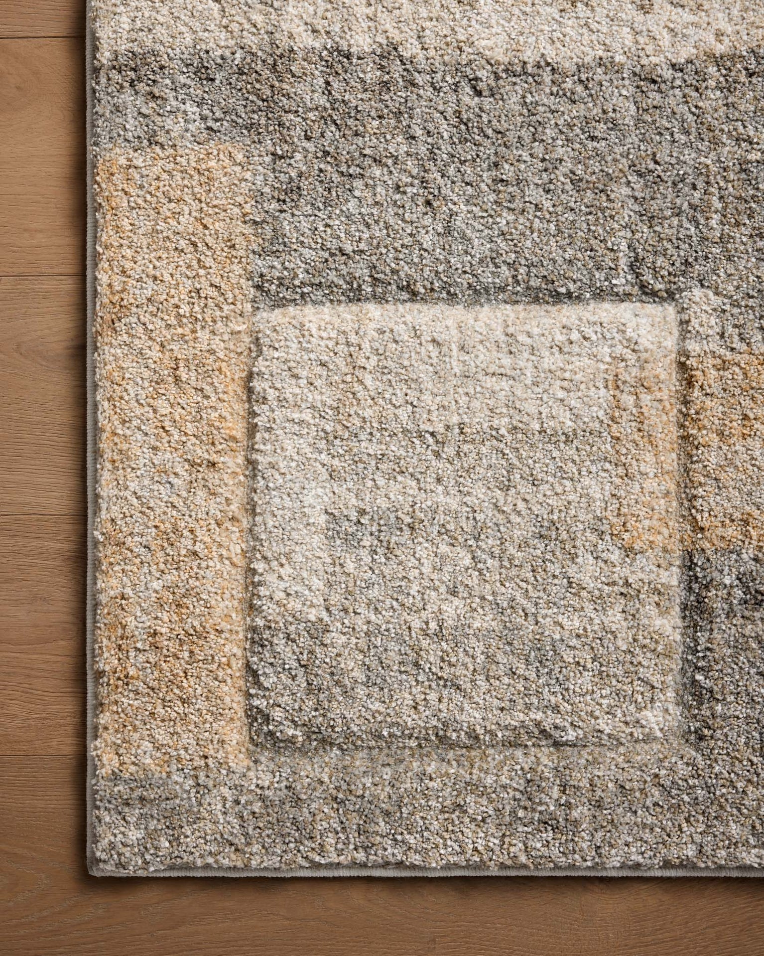 Modern geometric block pattern rug in beige, grey, and tan tones