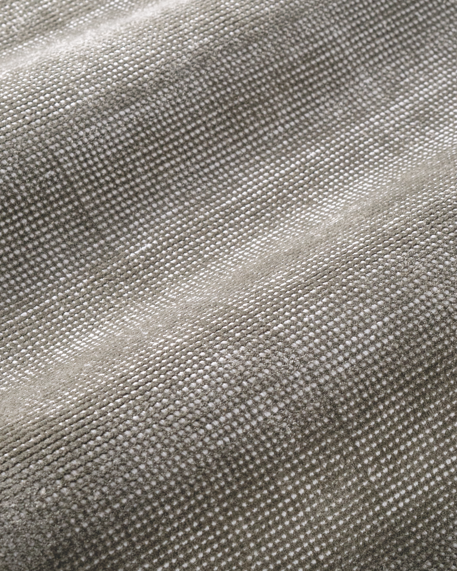 Soft grey velvet rug with subtle texture and neutral tone, rectangular shape