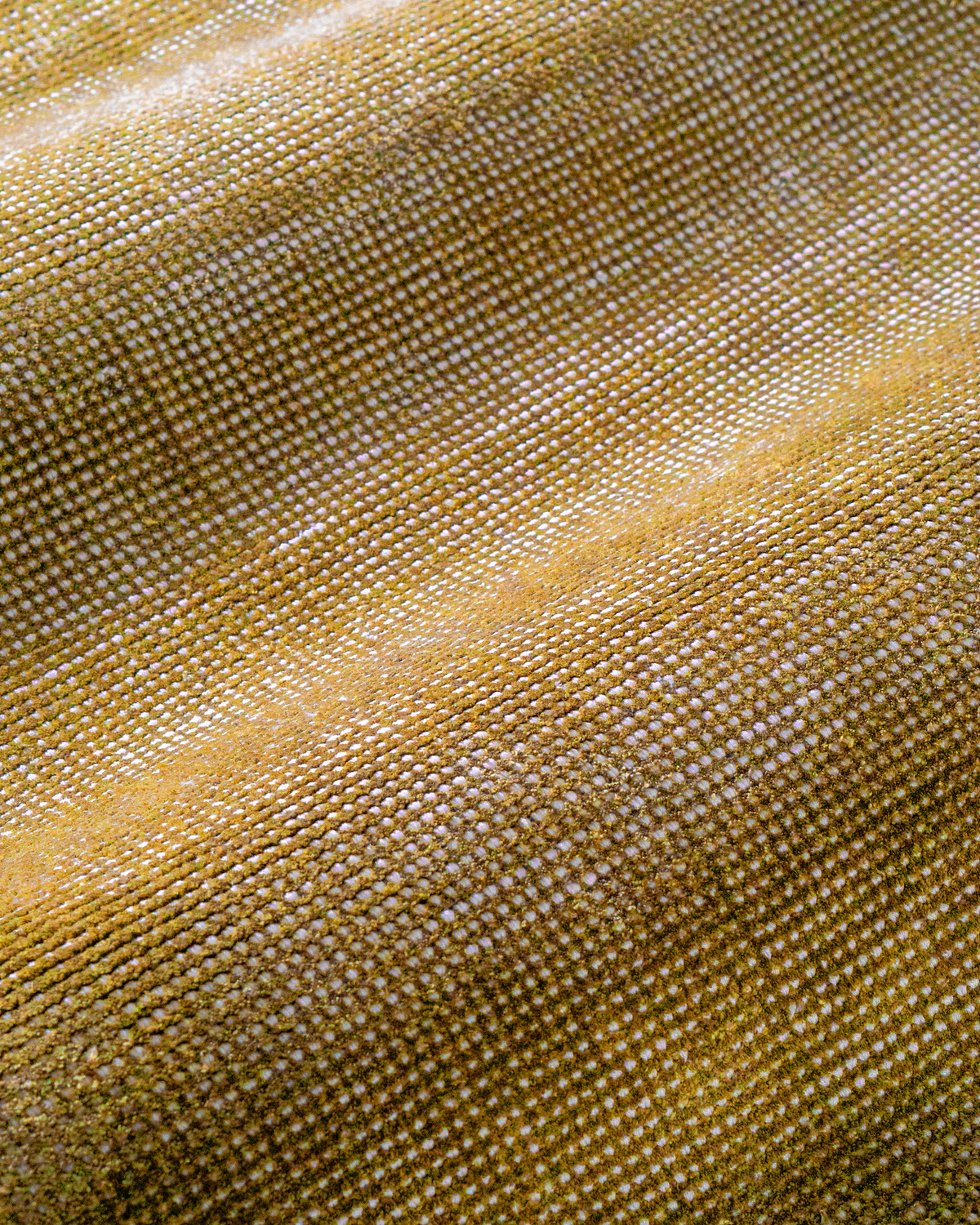 Golden yellow velvet rug with subtle grid texture pattern and worn vintage finish