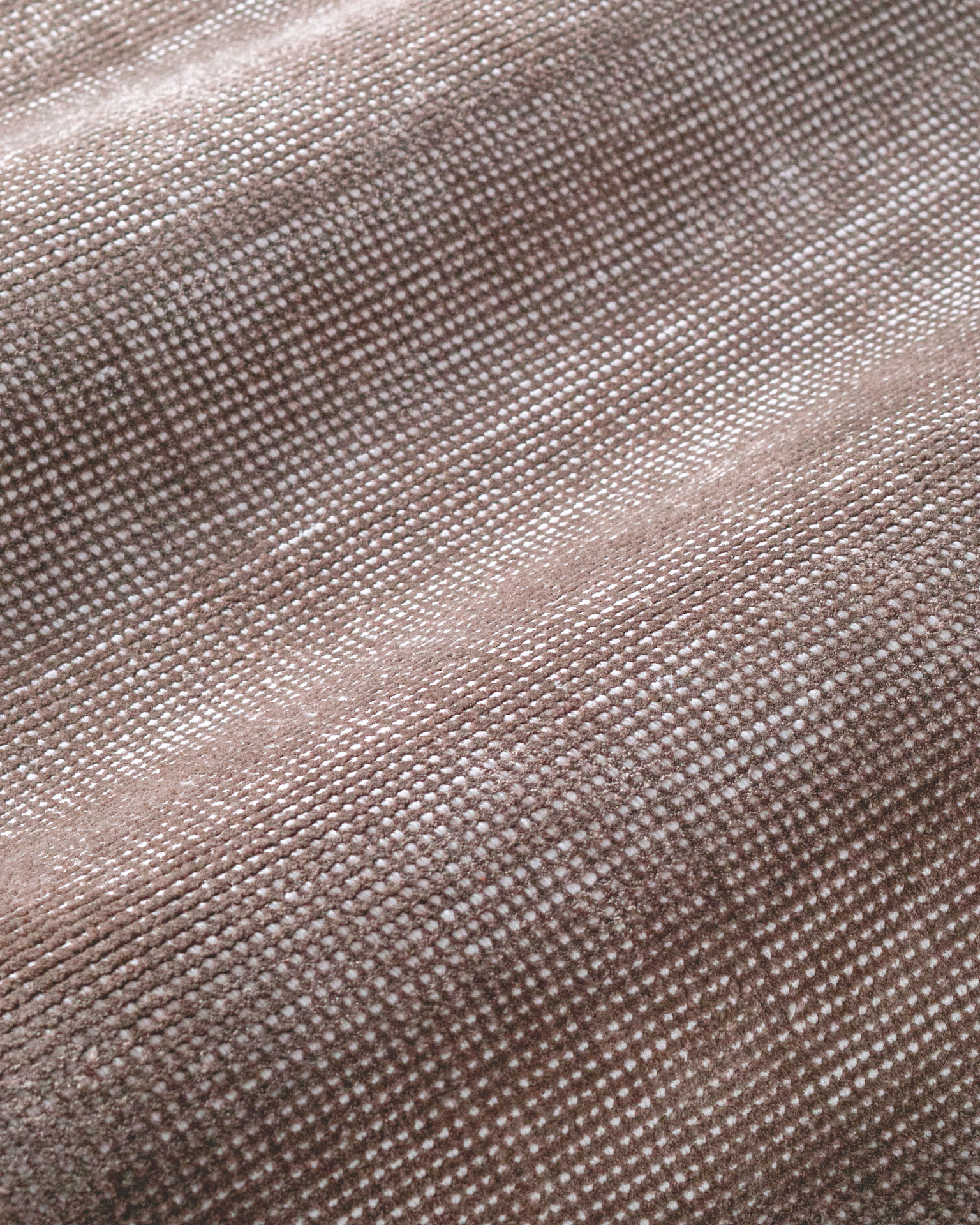 Soft taupe velvet rug with subtle texture and minimalist design