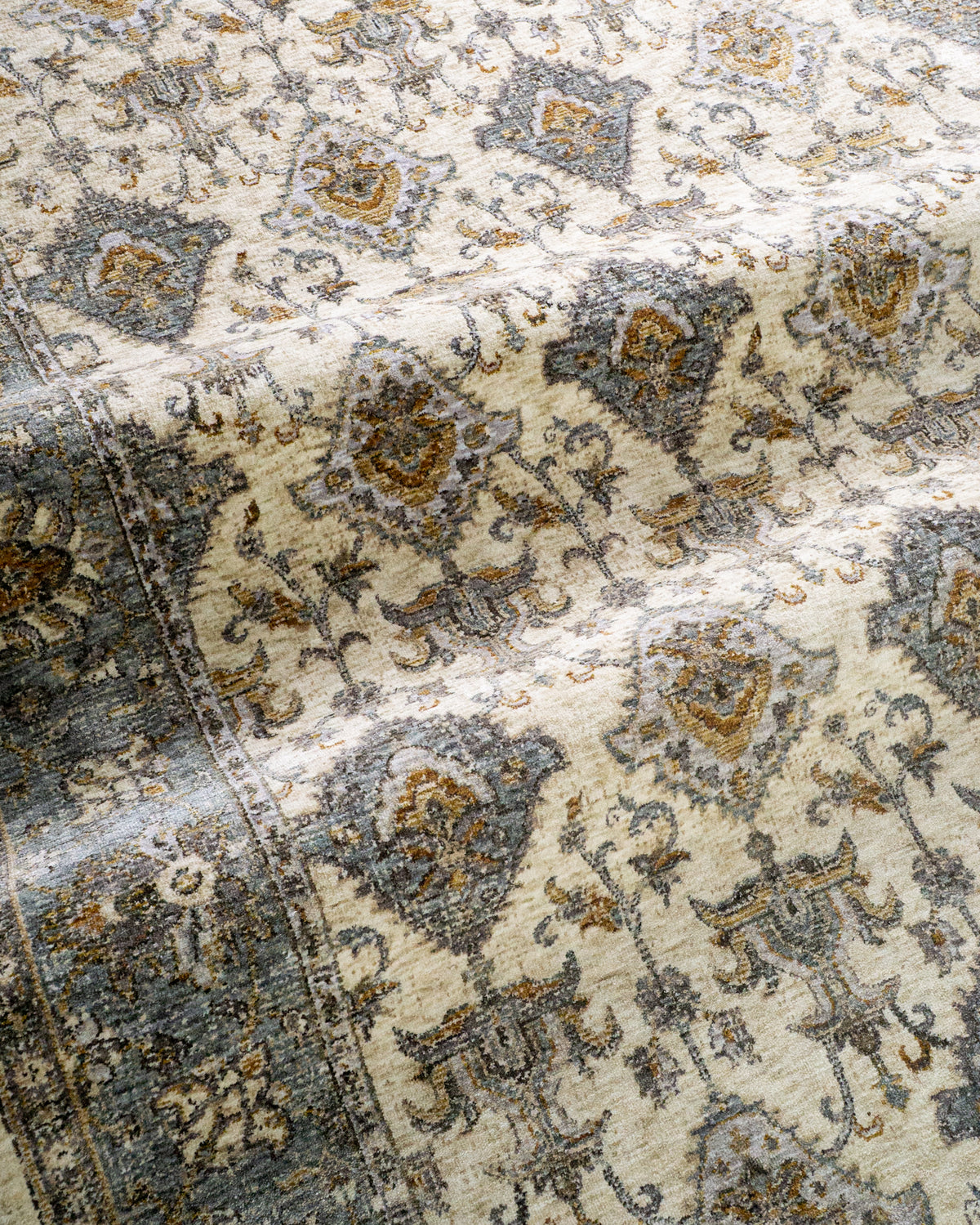 Cream and blue traditional rug with geometric diamond patterns and ornate border