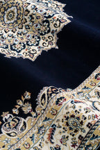 Black and gold traditional Persian style rug with ornate medallion pattern