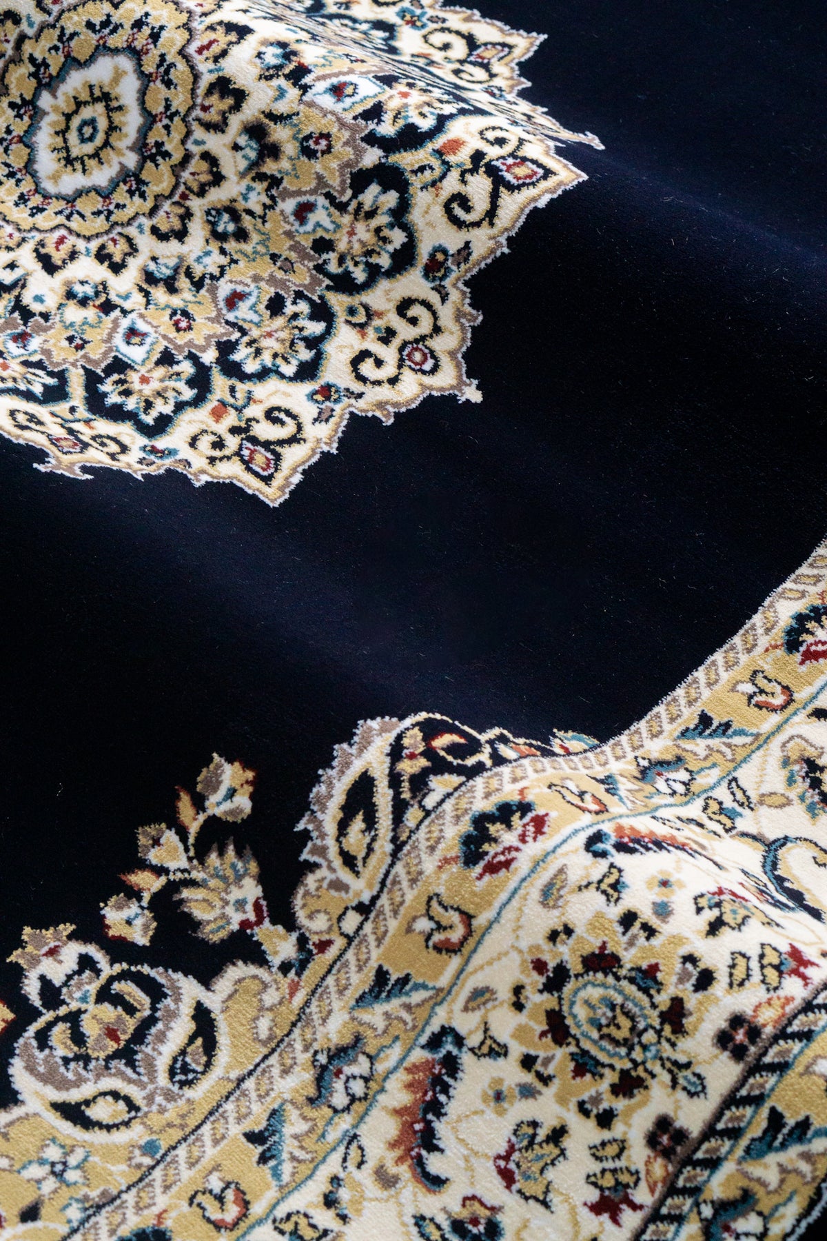 Black and gold traditional Persian style rug with ornate medallion pattern
